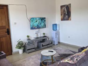 a living room with a couch and a table at Breezy hideaway malindi 2br in Malindi