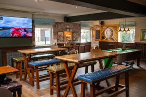 a restaurant with ping pong tables and a flat screen tv at The Longship in Hebburn-on-Tyne