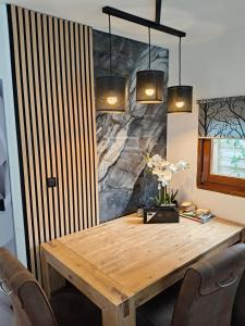 a dining room with a wooden table and chairs at Chalet Timber -close to the woods in Anloo