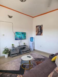 a living room with a couch and a table at Breezy hideaway malindi 2br in Malindi