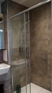 a shower with a glass door in a bathroom at Beautiful Flat 2-Mins away from Rochester Station in Rochester +12 photos