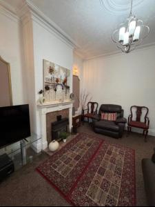 a living room with a fireplace and a tv at Rotherham Meadowhall in Rotherham