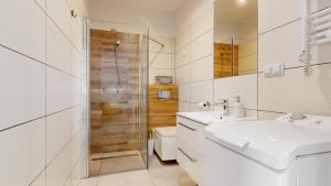a white bathroom with a sink and a shower at Studio Fibra Lungo in Rybnik