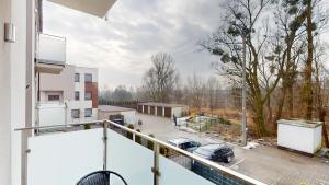 a balcony with a view of a parking lot at Studio Fibra Lungo in Rybnik