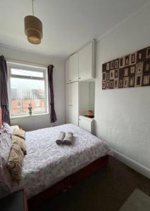 a bedroom with a bed with two slippers on it at Rotherham Meadowhall in Rotherham