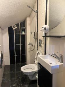 a small bathroom with a toilet and a sink at Taksim Pera Premium Gold Hotel in Istanbul +51 photos