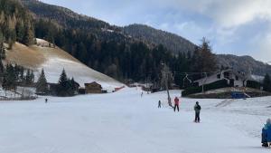 a group of people skiing on a snow covered slope at Haus RuHe in Döllach
