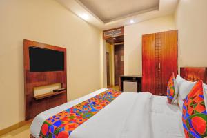 a hotel room with a bed and a television at FabHotel Smart Inn-1 in Gurgaon