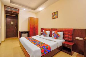 a bedroom with a large bed in a room at FabHotel Smart Inn-1 in Gurgaon