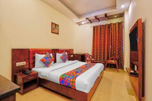 a bedroom with a bed and a television in it at FabHotel Smart Inn-1 in Gurgaon