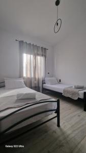a bedroom with two beds and a window at Villa Sofia in Kalives Poligirou