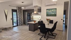 a kitchen and dining room with a table and chairs at Villa Sofia in Kalives Poligirou