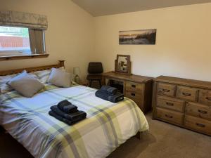 a bedroom with a bed with two towels on it at Hopeman Cottage in Hopeman