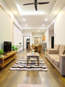 a living room with a couch and a table at Bayt Rizq Homestay 3R2B in Brinchang