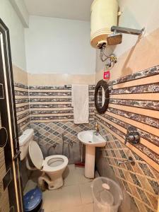 a bathroom with a toilet and a sink at OLT Hostel Rishikesh in Rishīkesh +42 photos