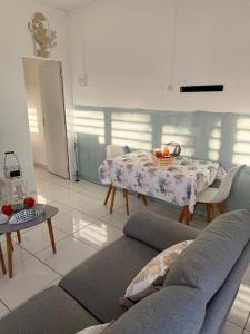a living room with a couch and a table at Charmant T2 sur le robert in Le Robert
