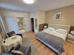 a bedroom with a bed and a table and chairs at Hotel Hotwagner in Maria Enzersdorf +29 photos