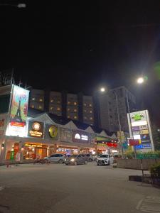 a city at night with cars parked in a parking lot at Bayt Rizq Homestay 3R2B in Brinchang