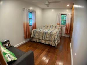 a bedroom with a bed and two windows at Roscoe Pine House in Roscoe