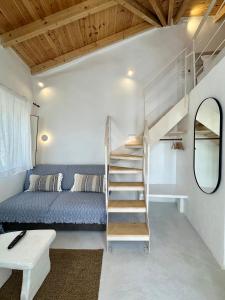a small room with a bunk bed and a staircase at Lythi Kythnos in Kithnos