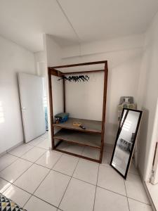a room with a mirror sitting on a tiled floor at Charmant T2 sur le robert in Le Robert