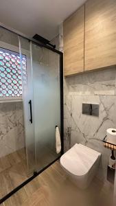 a bathroom with a shower and a toilet and a sink at Apartaments Platja d’Aro in Platja d'Aro +25 photos