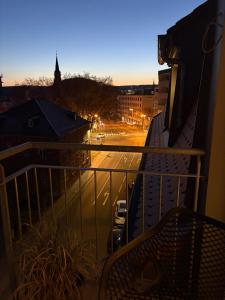 a balcony with a view of a street at night at Deluxe Loft in Bad Kissingen
