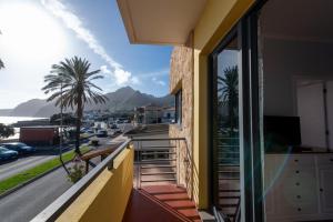 a balcony of a building with a view of a street at Apartamentos Amarelo in Caniçal