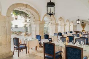 a dining room with tables and chairs in a building at Pousada Castelo de Palmela in Palmela