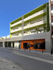 a large apartment building with a street in front of it at Ganalé Hôtel in Dakar