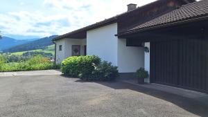 a house with a driveway next to a building at Gästehaus FaRitz in Knittelfeld