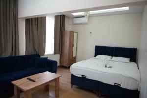 a bedroom with a bed and a blue couch at BDK hotel in Istanbul