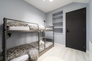 a bedroom with two bunk beds and a door at Ciné Suite - Arras 5 guests in Arras