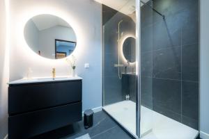 a bathroom with a shower and a sink and a mirror at Ciné Suite - Arras 5 guests in Arras