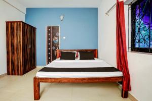 a bedroom with a bed in a room at Hotel O Kunal guest house in Goa