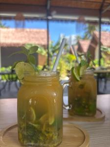 two mason jars of pickles on a table at Ambra Maldives in Thoddoo +41 photos