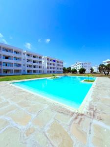 a large swimming pool in front of a building at Malindi Modern 2BR Near the Beach With a Private Pool in Malindi