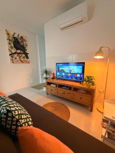 a living room with a flat screen tv on a table at Casa Melro in Faro