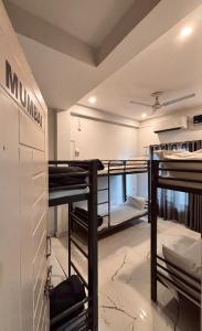 a room with several bunk beds in a room at OLT Hostel Rishikesh in Rishīkesh