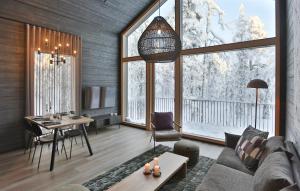 a living room with a couch and a table at Riekko Lodge in Äkäslompolo
