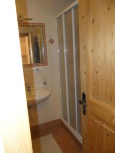 a bathroom with a sink and a toilet and a mirror at Appartamenti Stauderhof in Villabassa +17 photos
