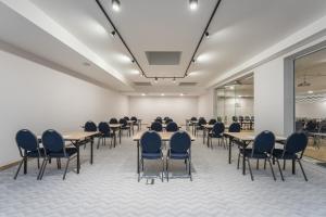 a meeting room with tables and chairs in a building at Platino Mare Resort & Spa in Świnoujście +90 photos