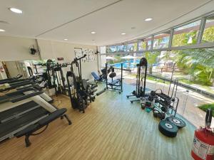 a gym with a bunch of treadmills and machines at Excelente Apto no condomínio Boulevard in Bombinhas
