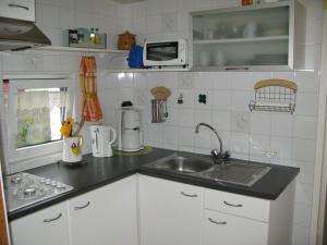 a kitchen with a sink and a counter top at Apartment Haus Jule by Interhome in Wervershoof