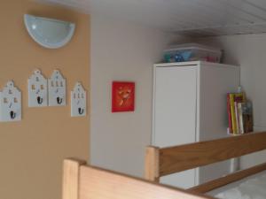 a bedroom with a white refrigerator and a shelf at Apartment Haus Jule by Interhome in Wervershoof