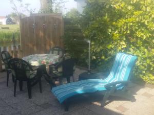 a patio with chairs and a table and a table and chairs at Apartment Haus Jule by Interhome in Wervershoof +9 photos