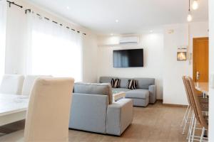 a living room with a couch and a table at Maka beach apartment v in Castelldefels