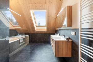 ein Badezimmer mit Waschbecken und Fenster in der Unterkunft Chalet Modriach - Private Sauna & Whirlpool in Modriach