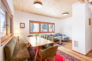 ein Wohnzimmer mit einem Tisch und einem Sofa in der Unterkunft Chalet Modriach - Private Sauna & Whirlpool in Modriach
