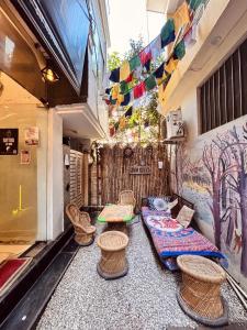 a room with tables and chairs and a wall with flags at OLT Hostel Rishikesh in Rishīkesh